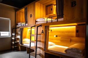 a group of bunk beds in a room at GUSTI Backpackers Capsule Hostel Singapore in Singapore