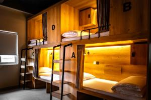 a group of bunk beds in a room at GUSTI Backpackers Capsule Hostel Singapore in Singapore