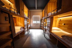 a room with a bunch of bunk beds at GUSTI Backpackers Capsule Hostel Singapore in Singapore +8 photos