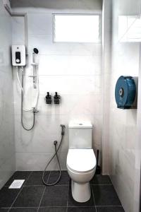a bathroom with a toilet and a shower at GUSTI Backpackers Capsule Hostel Singapore in Singapore