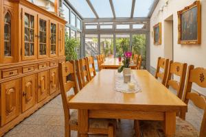 a dining room with a wooden table and chairs at Gästehaus Marietta in Osann-Monzel