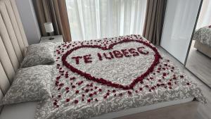 a heart pillow with the words im useless on a bed at Great View & Parking - Harmony Premium Residence in Timişoara