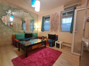 a living room with a couch and a table at Artsy fully equipped 2 bedrooms House all to yourself! in Bucharest
