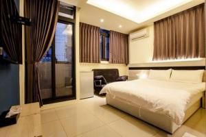 a bedroom with a large bed and a fireplace at Biau Tsan Su in Taichung