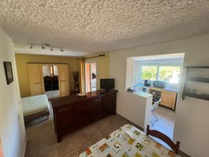 a bedroom with a bed and a desk with a computer at Appartements Calvi in Calvi +16 photos