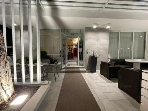 a lobby of a building with tables and chairs at Hotel Garden in Riccione