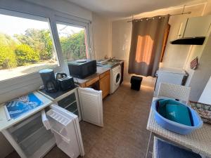 a small kitchen with a sink and a window at Appartements Calvi in Calvi