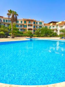 a large blue swimming pool in front of a building at BEACH HOUSE - Walkable to Beach - Wi-Fi Included in Santa Maria