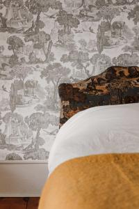 a bedroom with a wallpaper with elephants and trees at Little Louis - A Princely Take on a County Getaway in Mountain View