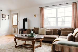 a living room with a couch and a coffee table at Little Louis - A Princely Take on a County Getaway in Mountain View
