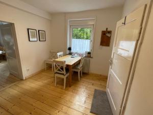 a kitchen and dining room with a table and a refrigerator at Landidyll am Knüll in Alheim