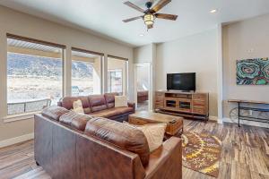 a living room with a couch and a flat screen tv at Rim View 6 in Spanish Valley