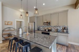 a kitchen with a counter and some stools in it at Rim View 6 in Spanish Valley +26 photos