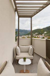 a balcony with a couch and a table at SIRO Boka Place in Tivat +95 photos