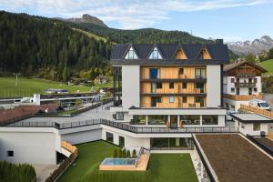 an aerial view of a building with mountains in the background at Berghotel in Racines