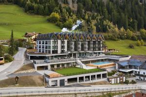 a large building with a train on top of it at Berghotel in Racines