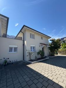 a white house with a bike parked in front of it at Charming family villa in Geneva