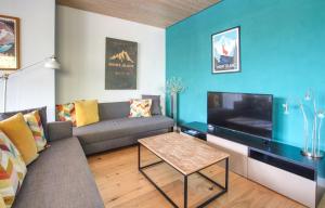 a living room with a couch and a tv at Gaillands North in Chamonix-Mont-Blanc