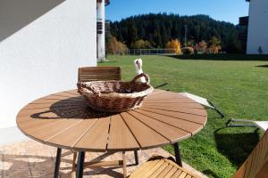 a basket sitting on top of a wooden table at Prada Laax by Quokka 360 - Alpine Residence with Shared Sauna in Laax