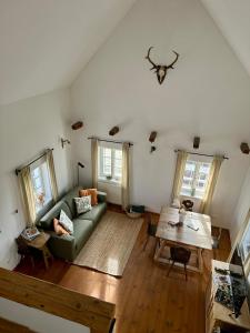 a living room with a couch and a table at Das KRANACH 28 in Fötschach