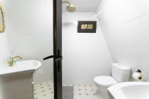 a bathroom with a toilet and a sink at Wood Side in Tʼerjola