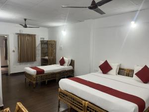 a room with two beds and a unintention at Sharmada Hidden Nest Resort in Jāmb
