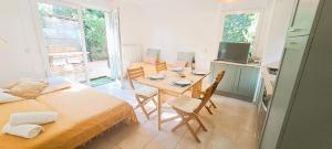 a bedroom with a bed and a table with chairs at Sérénité à l'Orée des bois in Le Teich
