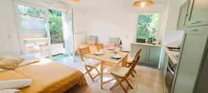a kitchen and dining room with a table and chairs at Sérénité à l'Orée des bois in Le Teich