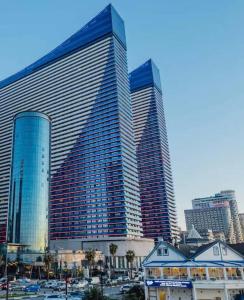a large building with tall skyscrapers in a city at Sunny Sea View Aparthotel in Orbi City Batumi in Batumi