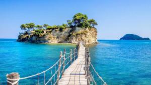 a bridge over the water with a small island at Margaret House in Zakynthos