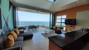 a living room with a view of the ocean at Luxury Beachfront Penthouse Umdloti in Umdloti