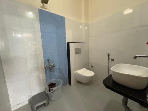 a bathroom with a sink and a toilet in it at Hotel chaitanya in Maheshwar +10 photos
