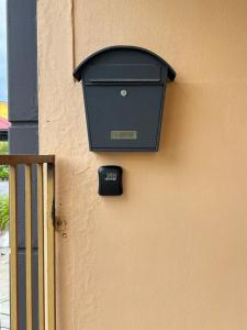 a mail box on the side of a building at Amani guesthouse in Padang Besar