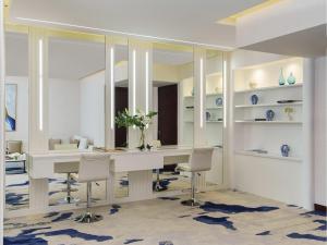 a room with a table and chairs and a mirror at Fairmont Bab Al Bahr in Abu Dhabi +194 photos