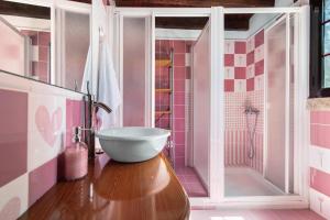a bathroom with a sink and a shower with pink tiles at Villa Alma in Vega de San Mateo +25 photos