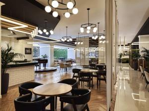 a restaurant with tables and chairs and a bar at Fairmont Bab Al Bahr in Abu Dhabi