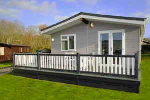 ミルフォード・オン・シーにある2 Bedroom Superior Lodge with Hot Tubの白柵の小屋