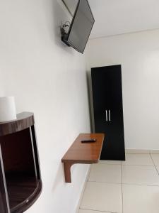 a room with a table and a tv on the wall at Hotel Ouro de Mauá in Mauá +42 photos