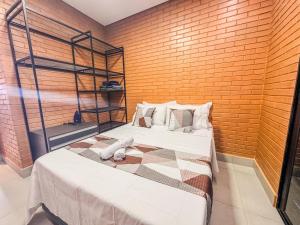 Postel nebo postele na pokoji v ubytování Maravilhoso loft com + ar condoicionado e vaga