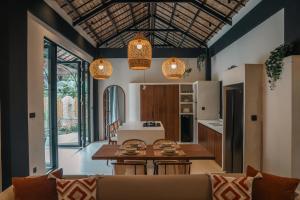 a kitchen and living room with a table and chairs at Alma Villas in Paliton