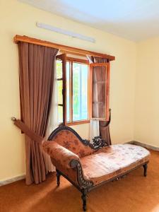 a room with a bed in front of a window at Shangrilla House Murree, Bhurban in Murree +17 photos