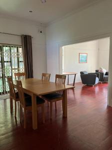 a dining room with a wooden table and chairs at Musgrave Escape in Durban