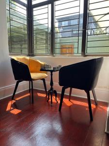 two chairs and a table in front of a window at Musgrave Escape in Durban