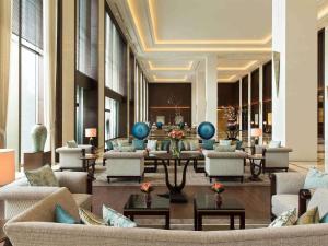 a lobby with couches and tables in a building at Fairmont Jakarta in Jakarta
