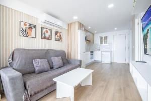 a living room with a couch and a table at Niza 11-A Apartment Levante Beach in Benidorm