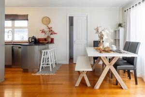 a kitchen and dining room with a table and chairs at Charming home on Percy in Devonport +8 photos