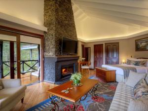 a hotel room with a bed and a fireplace at Fairmont Mount Kenya Safari Club in Nanyuki