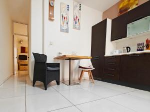 a kitchen with a table and chairs in a room at Corner view 2 in Marsaskala