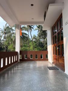 an empty room with a large wooden door at Gajalee Beach House in Bhogwe