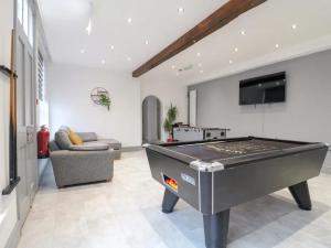a living room with a pool table in it at Hambleton House in Castle Donington